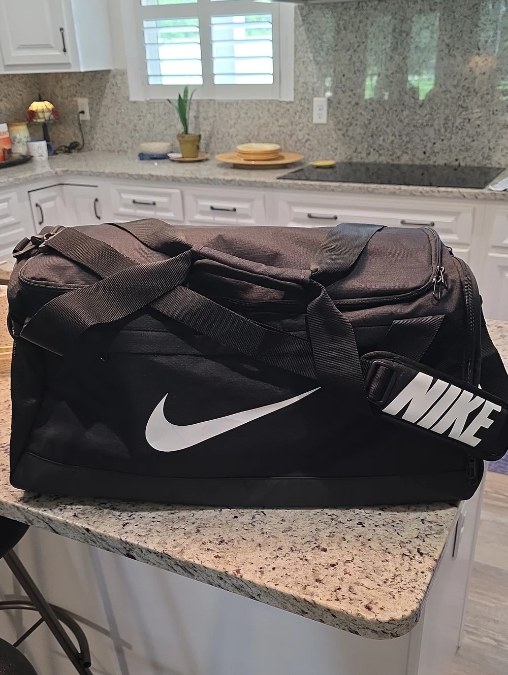 Nike Black Duffel Bag with White Swoosh and Branded Strap